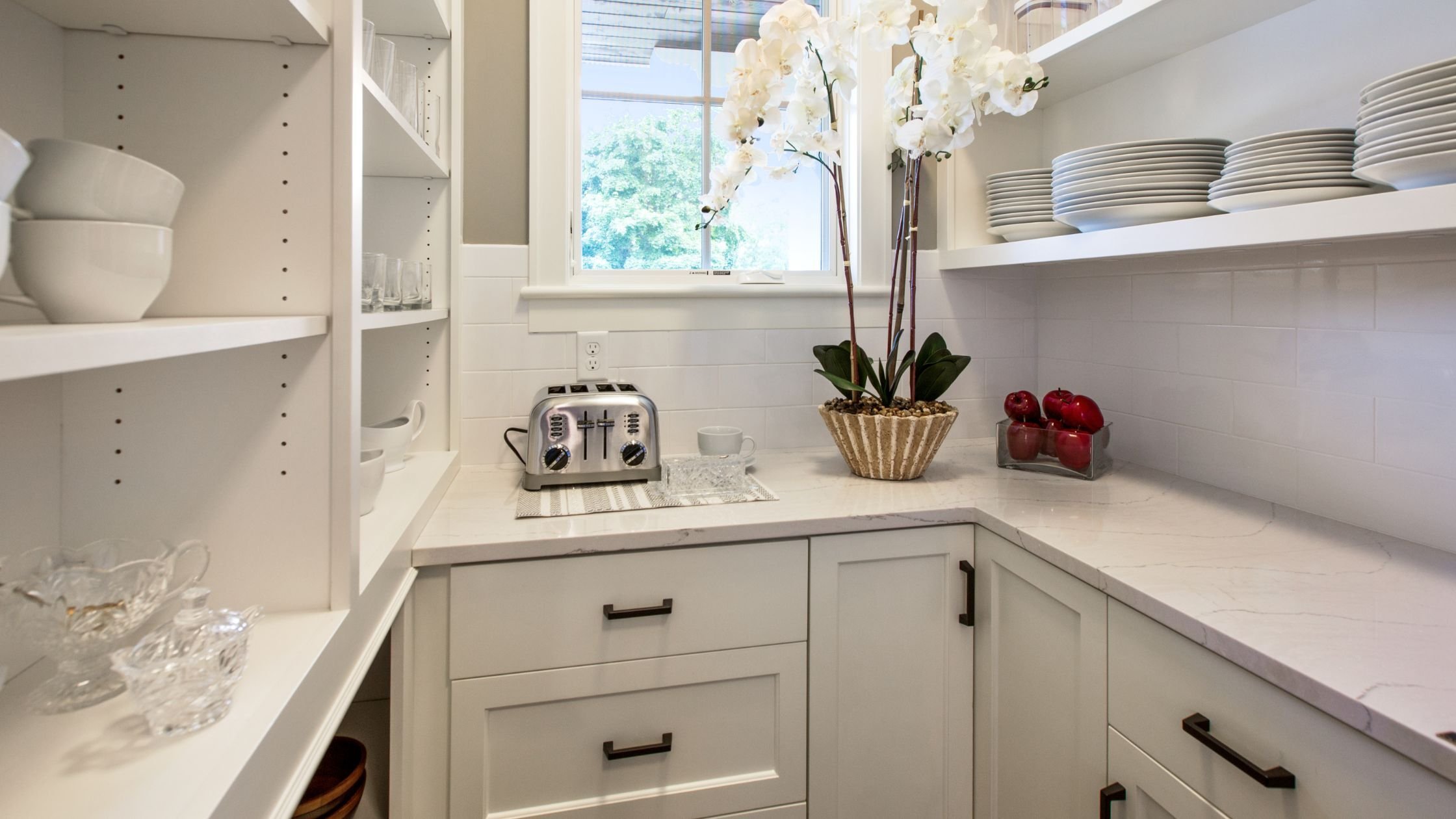 Butler pantry in an arizona home remodel with white cabinets and shelving