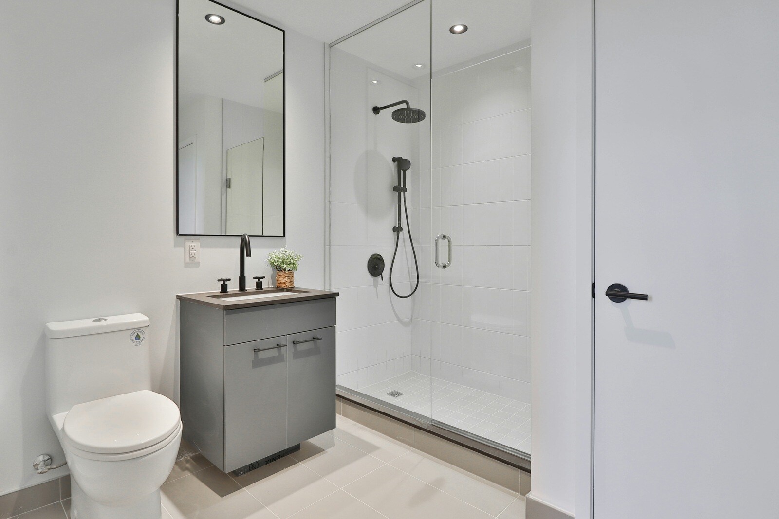 Modern bathroom remodel with a sleek walk-in shower and gray vanity by Crosby Home Services in Prescott, AZ