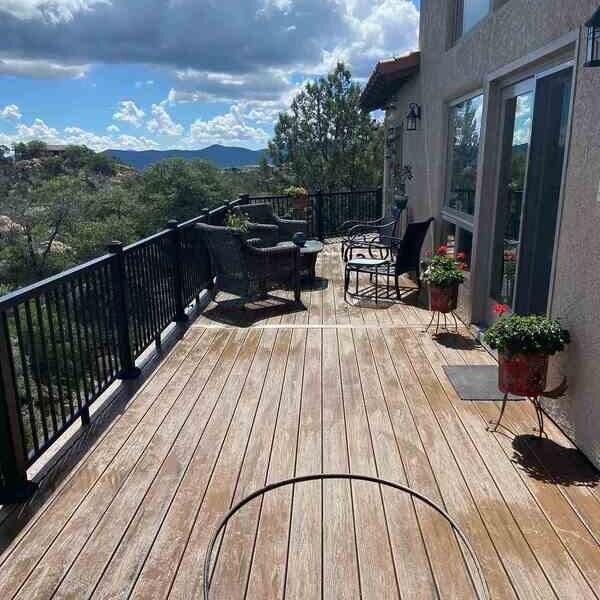 Scenic view from a deck remodel project by Crosby Home Services in Prescott, AZ, with outdoor seating and lush surroundings-1 Scenic view from a deck remodel project by Crosby Home Services in Prescott, AZ, with outdoor seating and lush surroundings-1