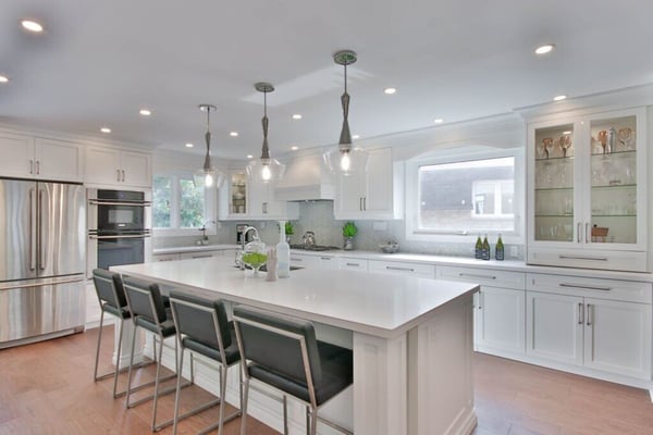 Remodeled kitchen with white countertops and cabinets