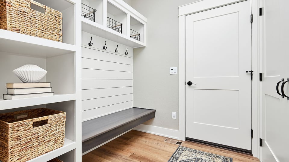 black and white mudroom with shiplap wall and wicker basket storage in an arizona home remodel