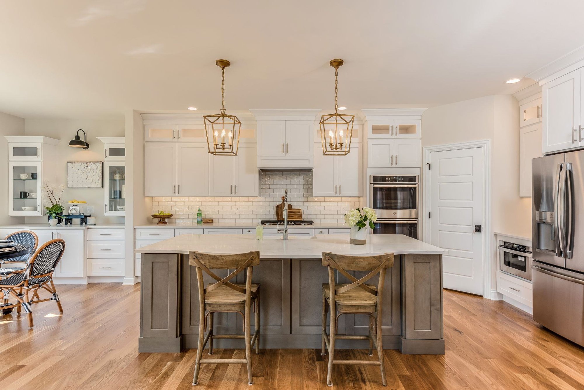 custom arizona kitchen remodel with two-tone cabinetry, large kitchen island, and custom lighting