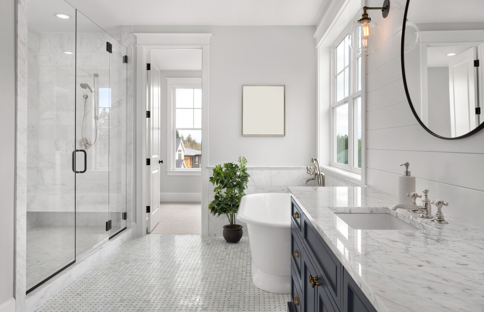 Luxurious bathroom remodel with marble finishes and a standalone tub by Crosby Home Services in Prescott, AZ