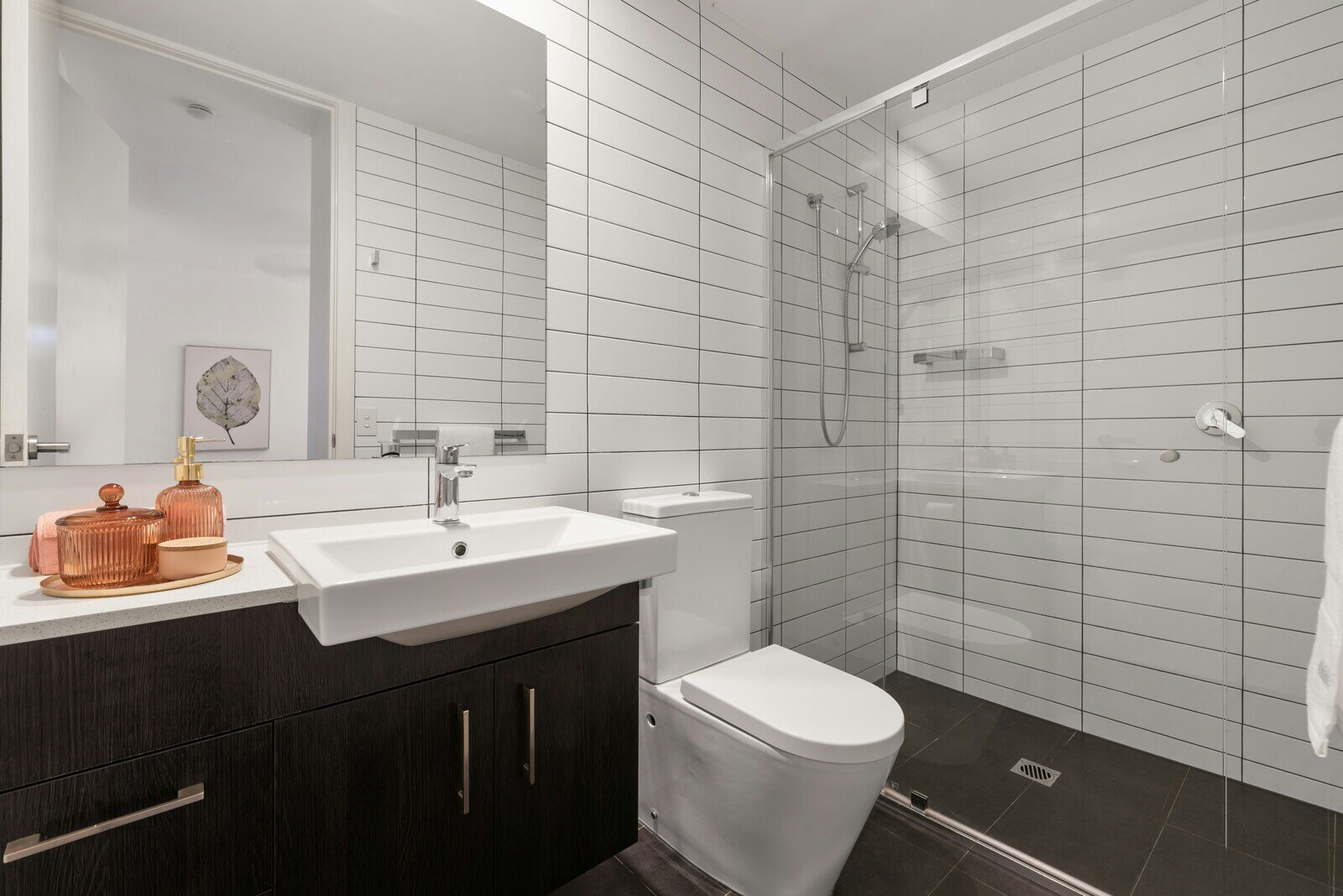 Contemporary bathroom remodel with white subway tiles, a glass-enclosed shower, and a modern vanity by Crosby Home Services in Prescott, AZ