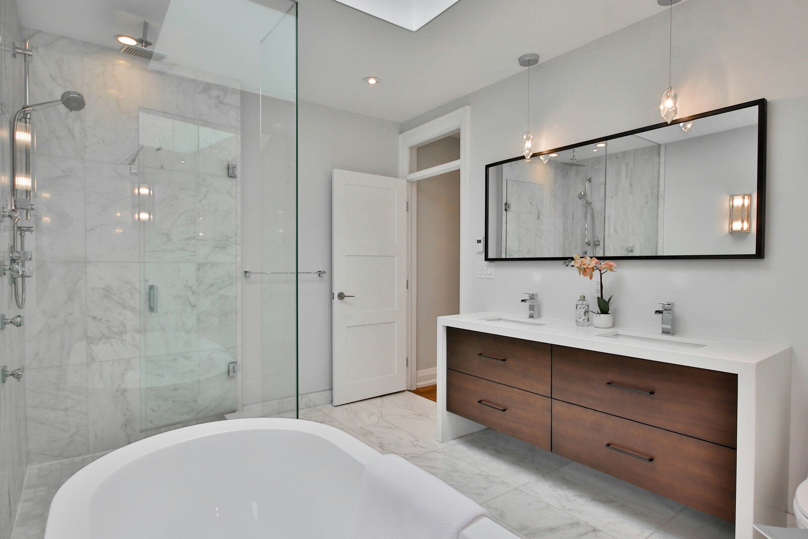 Luxurious bathroom remodel featuring a marble shower, freestanding tub, and double vanity in Prescott, AZ by Crosby Home Services