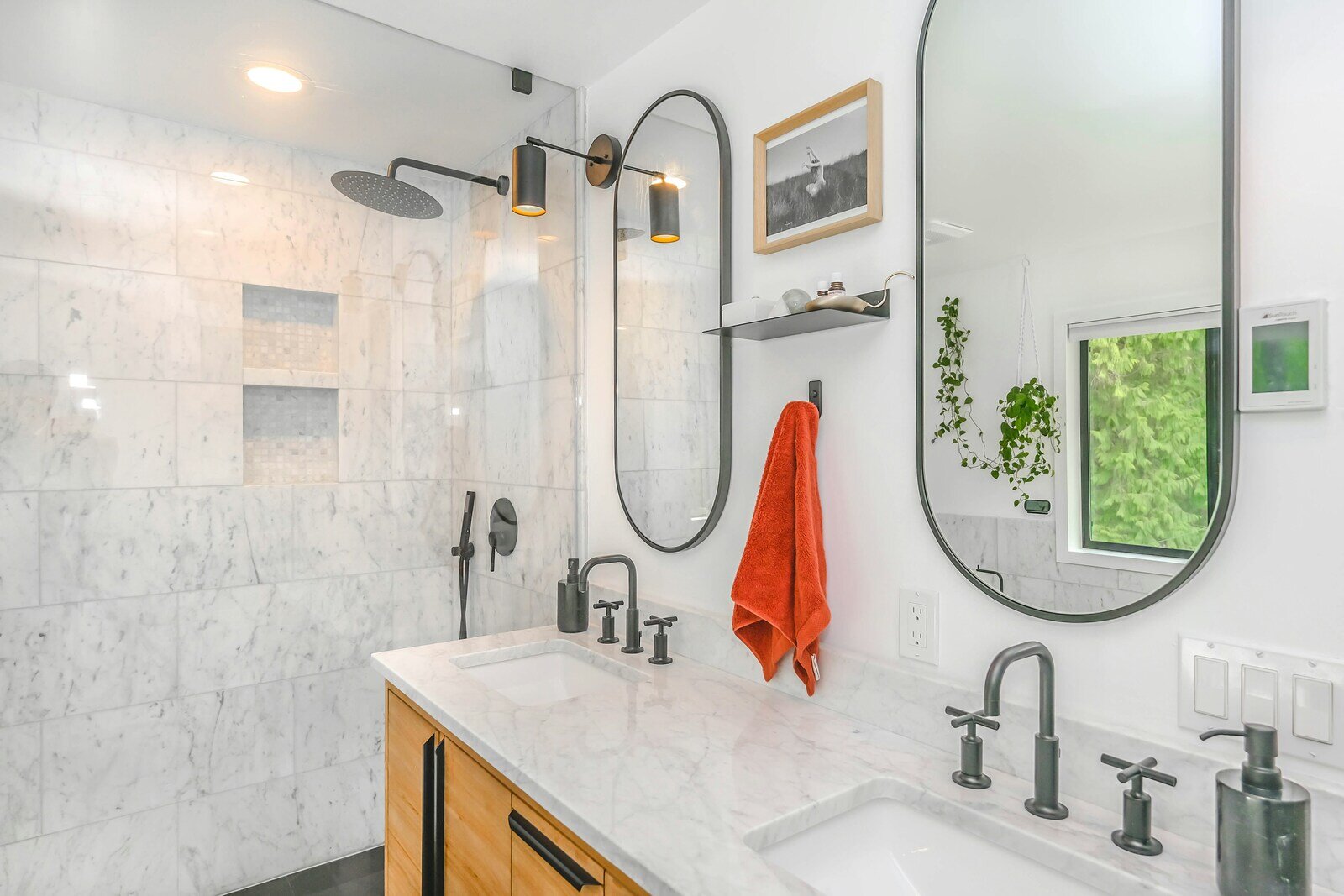 Luxurious bathroom remodel with marble finishes, a glass-enclosed shower, and modern double sinks in Prescott, AZ by Crosby Home Services