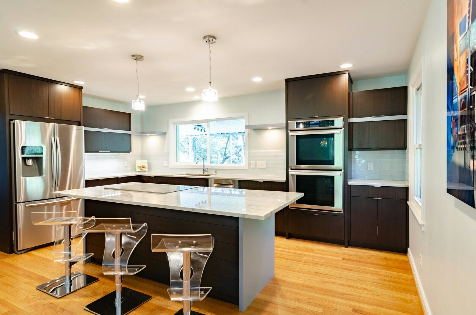 Sleek, contemporary kitchen remodel with dark cabinetry, stainless steel appliances, and a center island in Prescott, AZ by Crosby Home Services