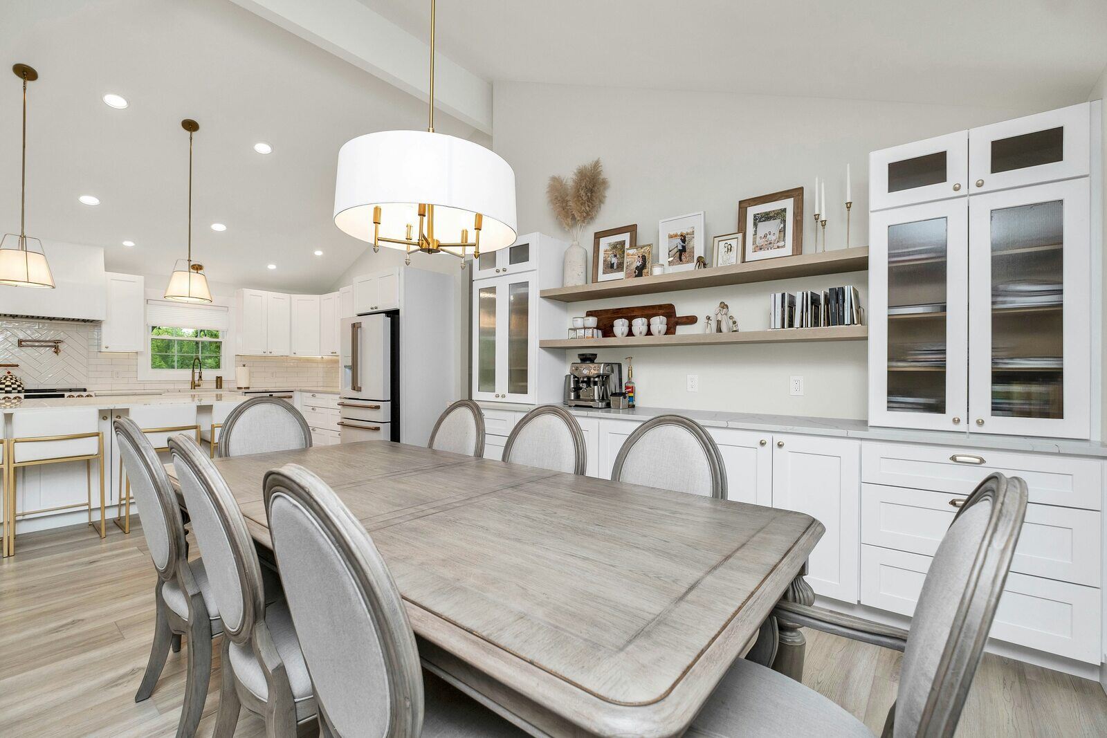 Stylish dining room adjacent to a modern kitchen remodel with white cabinets and gold accents in Prescott, AZ by Crosby Home Services