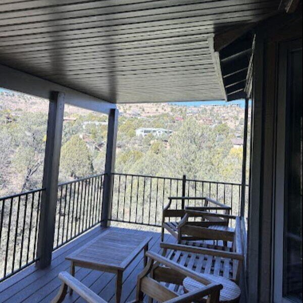 Covered balcony remodel with outdoor seating overlooking scenic Prescott, AZ, by Crosby Home Services-1