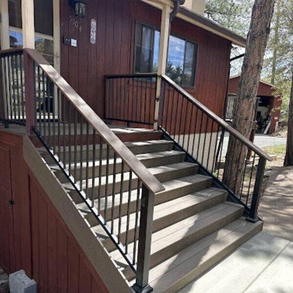 Newly built wooden stairs with black metal railings as part of a home improvement project in Prescott, AZ, by Crosby Home Services-1