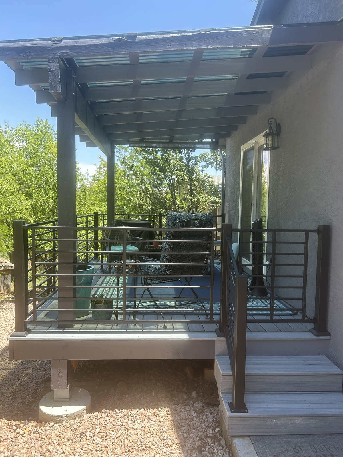 A modern deck with wooden beams and comfortable seating by Crosby Home Services in Prescott, AZ