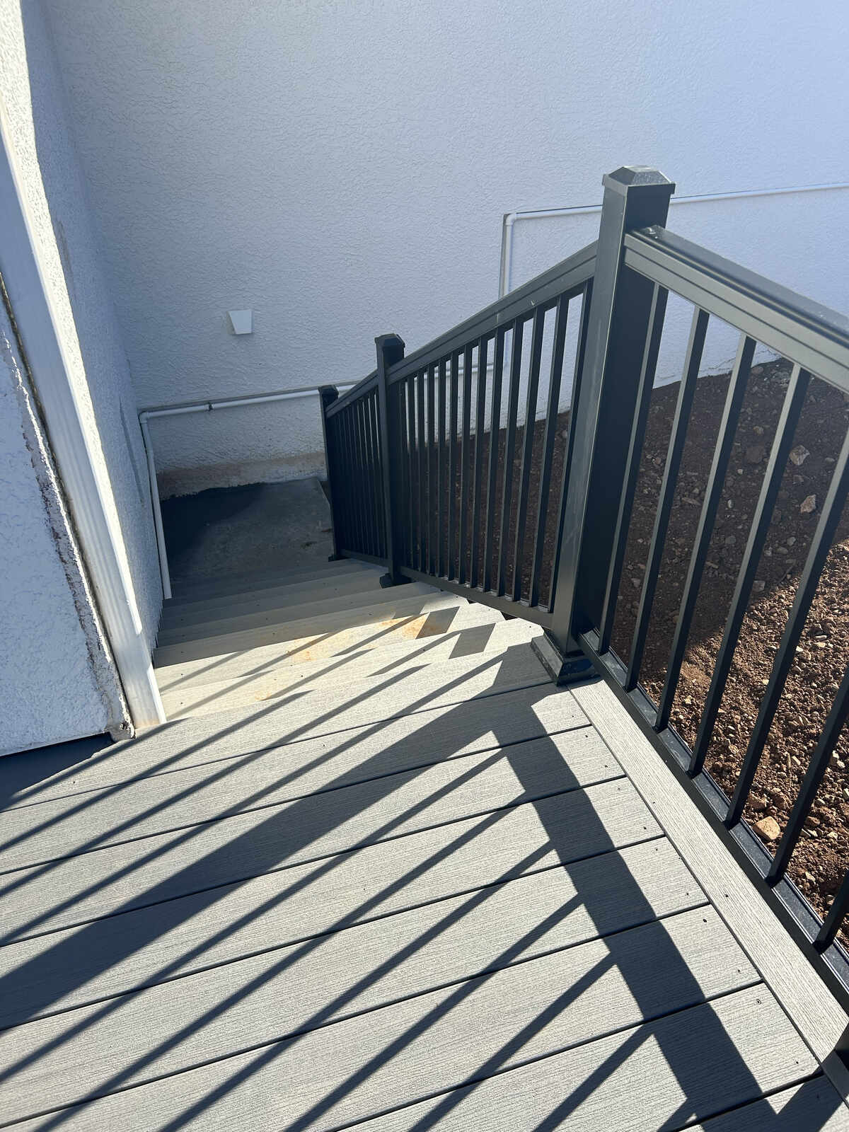 A newly installed outdoor staircase with black railings by Crosby Home Services in Prescott, AZ