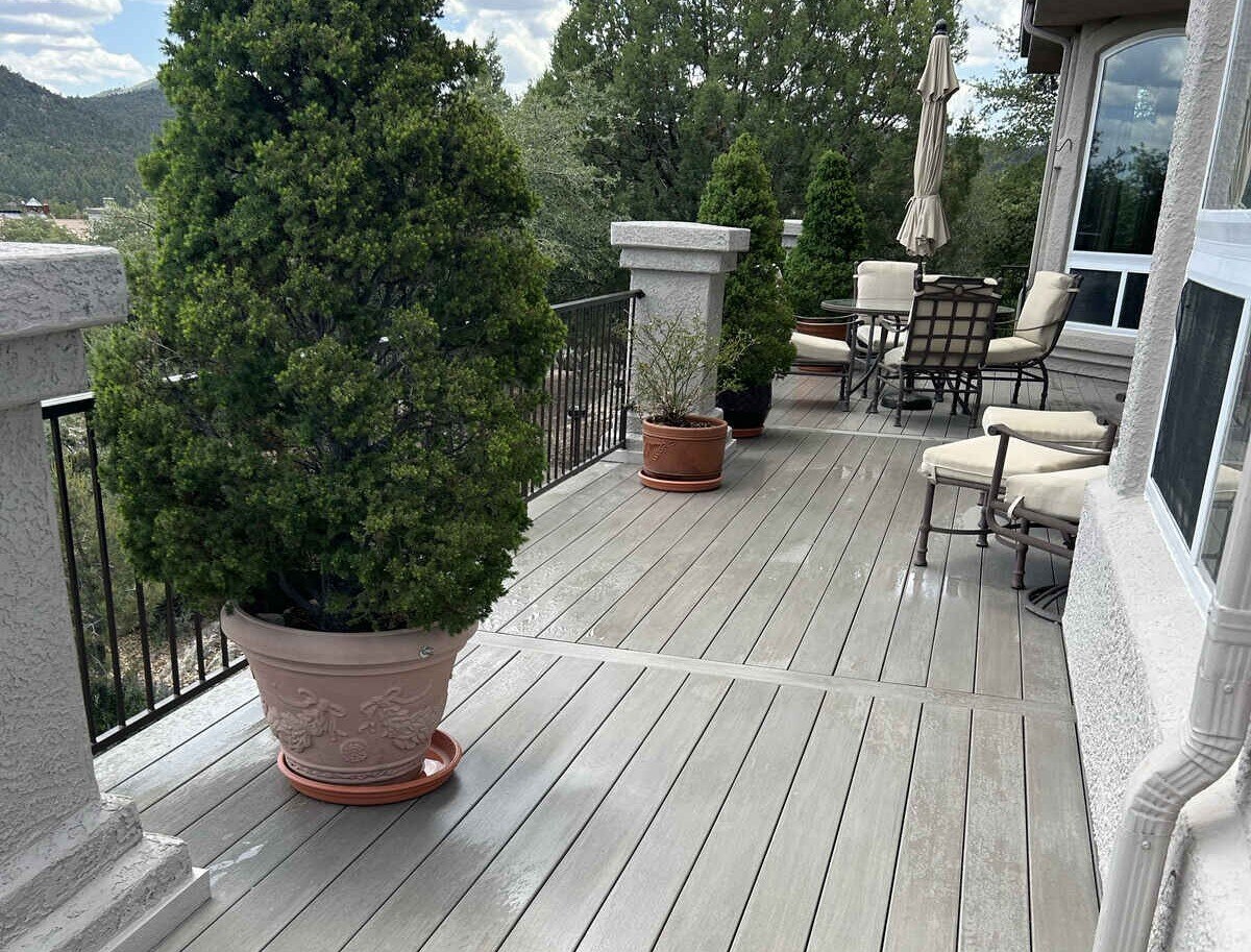 Contemporary outdoor deck with railing and potted trees by Crosby Home Services in Prescott, AZ