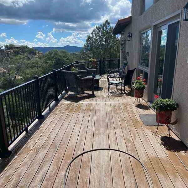 Scenic view from a deck remodel project by Crosby Home Services in Prescott, AZ, with outdoor seating and lush surroundings-1